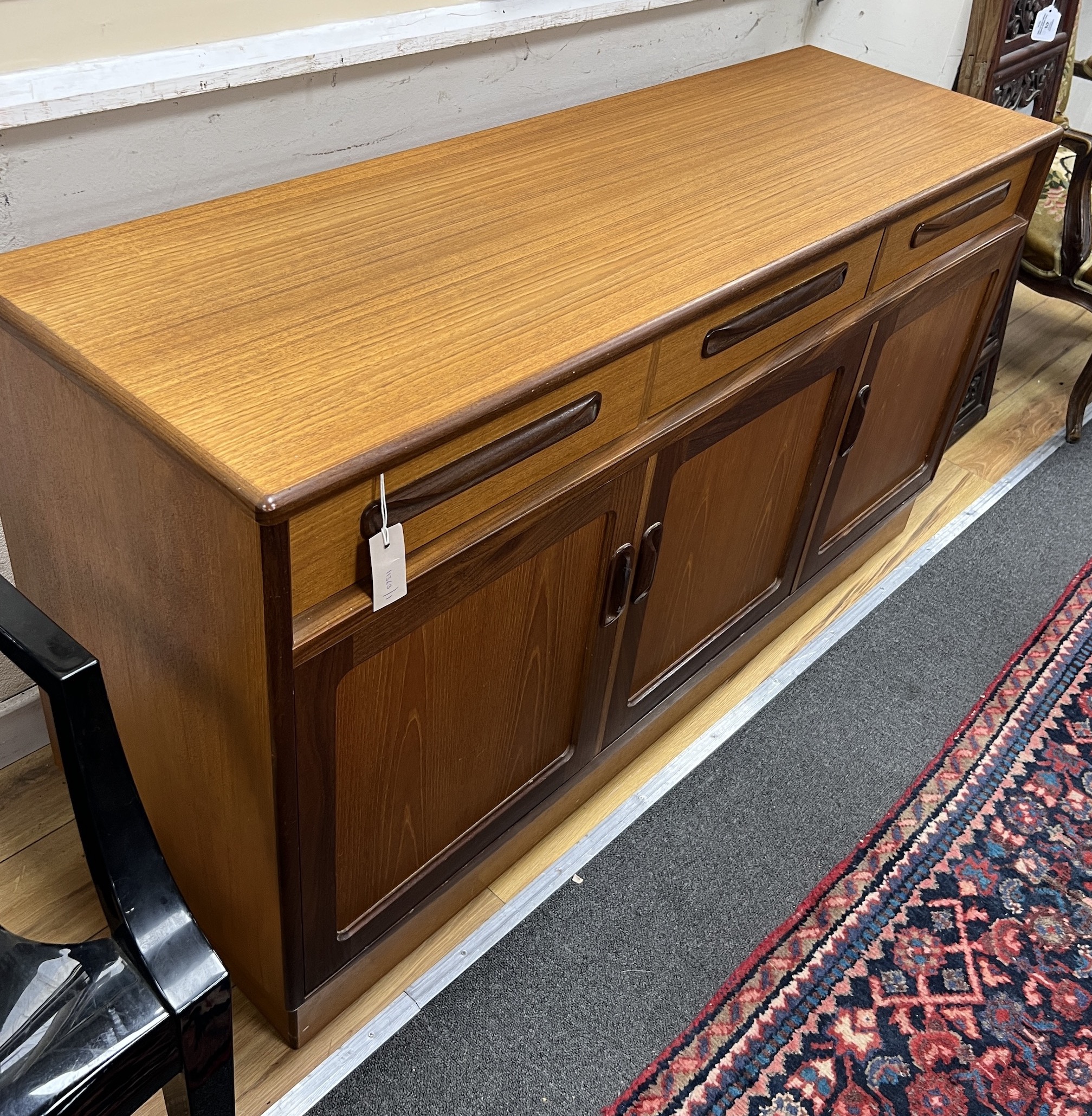 A mid century G Plan teak sideboard, length 142cm, depth 44cm, height 76cm